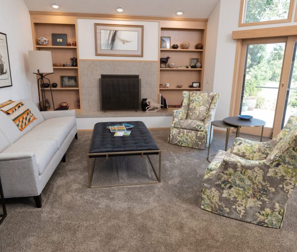 Built-in shelves and a central fireplace give this living room a clear focal point, while soft seating keeps the space relaxed and livable.