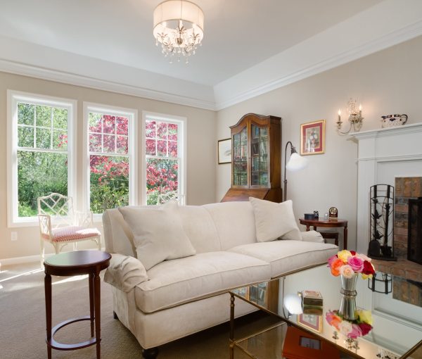 A light-filled living room where soft seating, a working fireplace, and collected details create a warm place to gather.